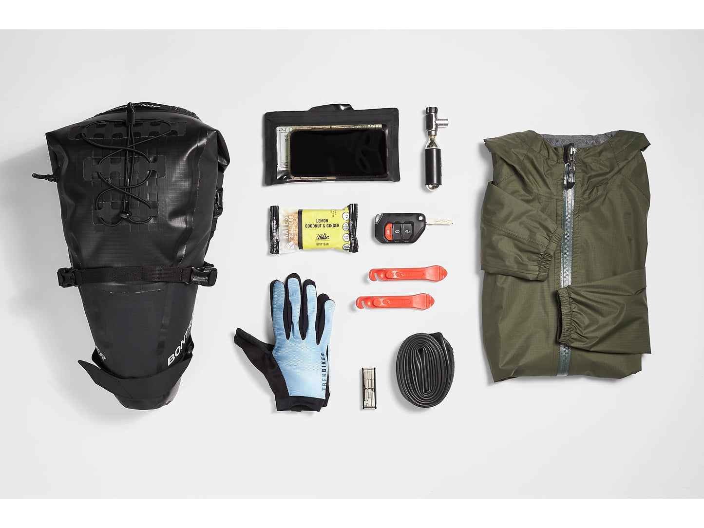 Bontrager Adventure Saddle Bag accessories to show how much can fit in with a white background