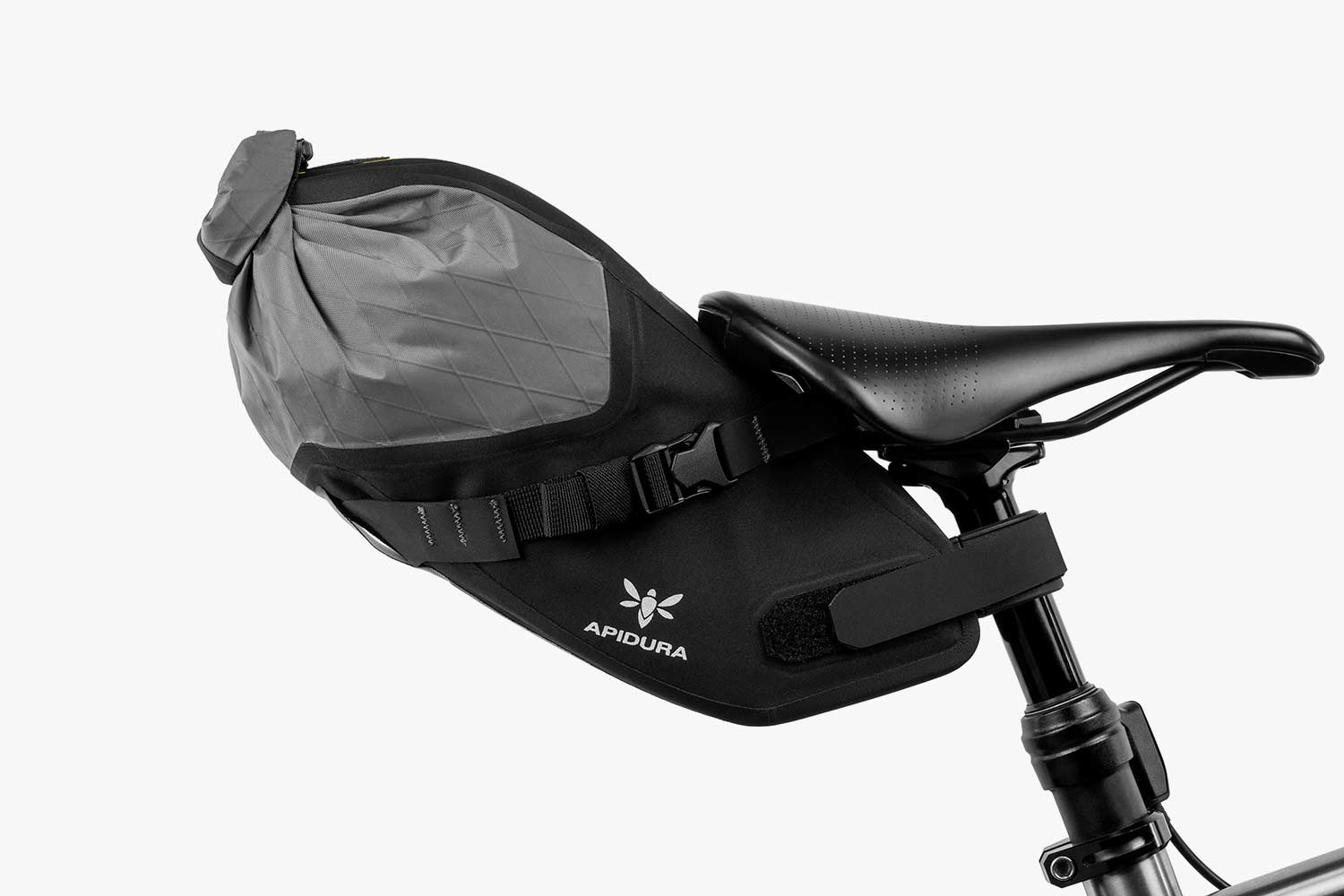 Apidura Backcountry Saddle Pack on the back of a bike with a white background