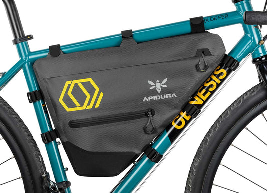 Apidura Full Frame Bag on a bikes bar with a white background