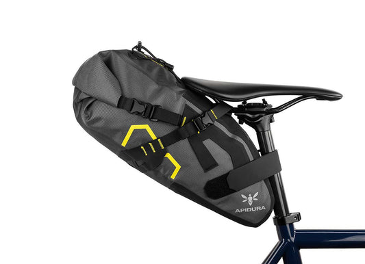 Apidura expedition saddle pack 9L attached to the back of a bike